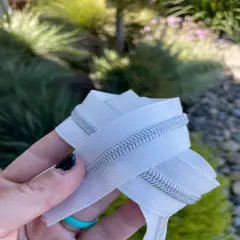 White zipper tape with iridescent teeth