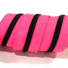 Black teeth on neon pink zipper tape