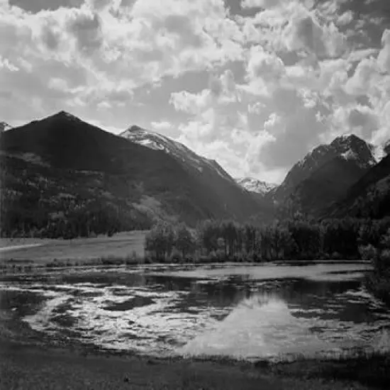 Lake and trees in foreground, mountains and clouds in background, in Rocky Mountain National Park, C Poster Print by Ansel Adams - Item # VARPDX460958 {1}