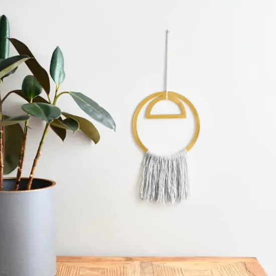 Hello Honey&reg; Gold Round Metal Wall Hanging with Tassel {3}