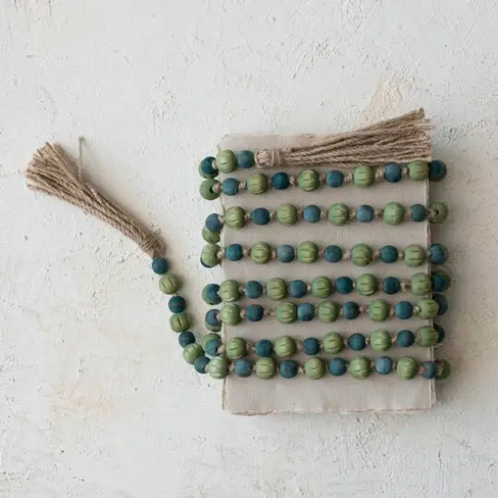 Hello Honey® 12ft. Green & Blue Paulownia Wood Beads with Jute Tassels Garland {4}
