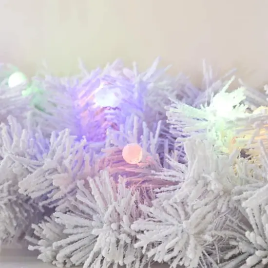 Glitzhome&reg; 9ft Pre-Lit Snow Flocked White Pine Christmas Garland with Timer {6}