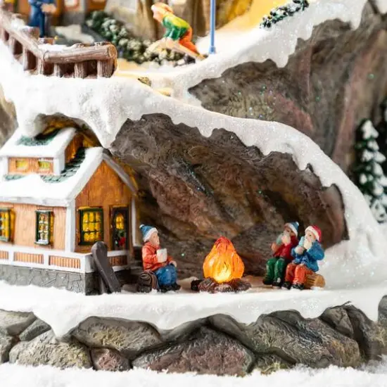 Glitzhome® 15.5" Lighted Christmas Skiing Moutain Resin Village with Movement and Music {7}